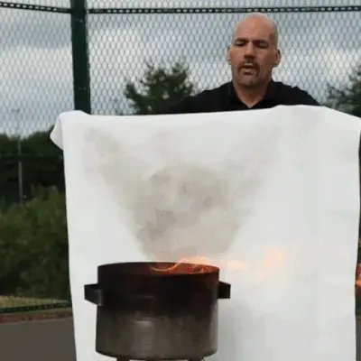 Prepared Hero fire blanket deploying from its pull-tab pouch